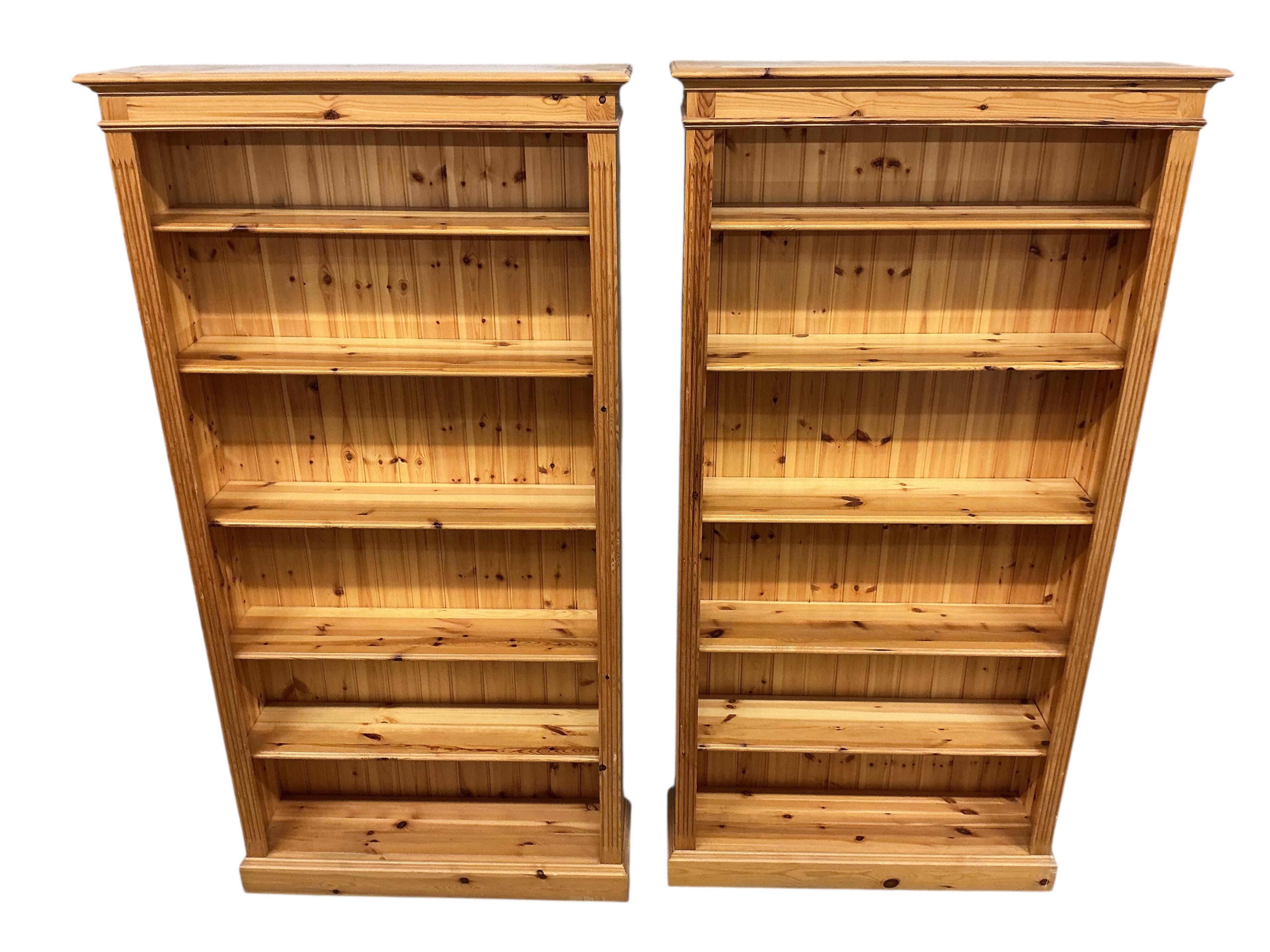 A pair of modern pine open bookcases, width 109cm, depth 29cm, height 212cm